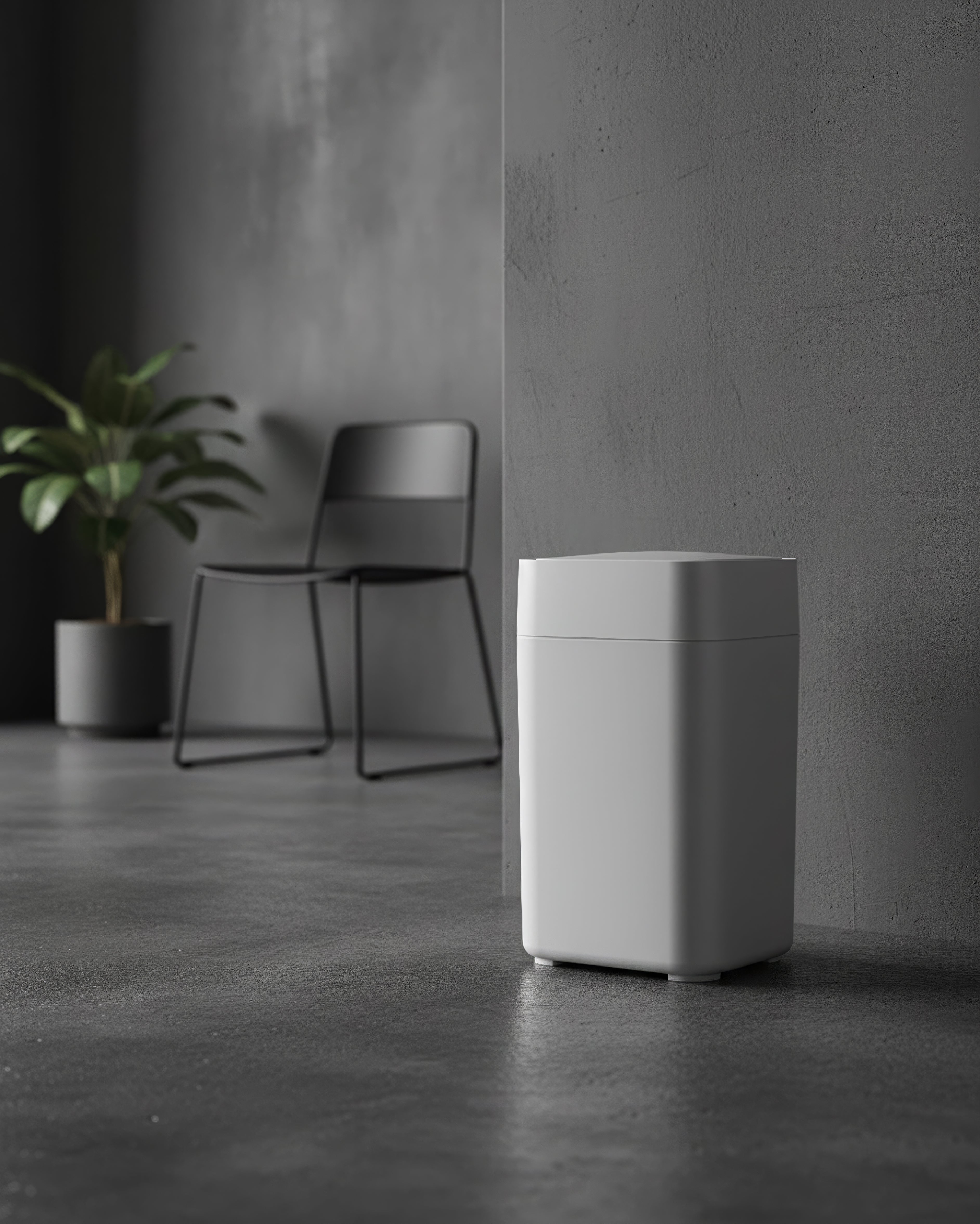 White trash bin in a minimalistic room with a chair and plant
